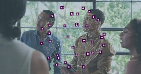 Diverse team collaborating with digital connectivity overlay while brainstorming on tablet