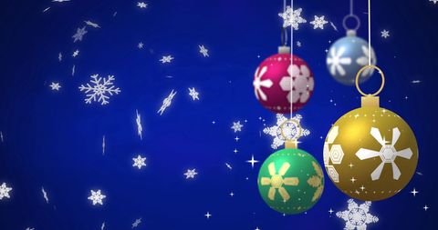 Festive Baubles with Falling Snowflakes on Blue Background