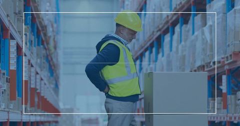 Warehouse Worker Inspecting Packed Box on Pallet in Aisle