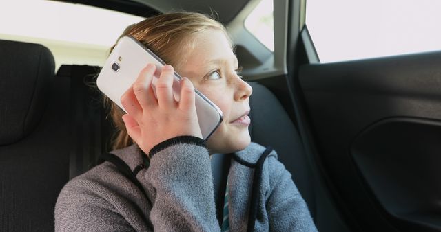 Smiling Girl Talking on Smartphone While Traveling by Car - Download Free Stock Images Pikwizard.com