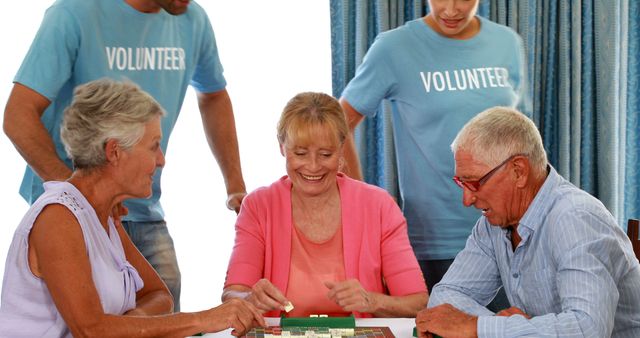 Seniors Playing Board Game with Volunteers in Community Center - Download Free Stock Images Pikwizard.com