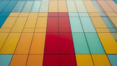 Dynamic Panning Across Multicolored Building Facade with Geometric Panels