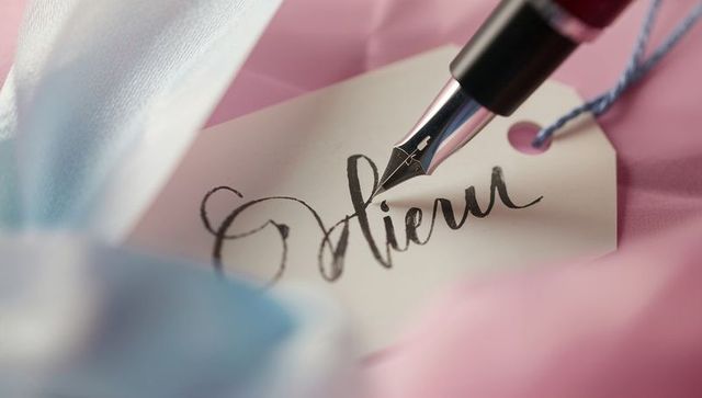 Elegant calligraphy on gift tag with fountain pen