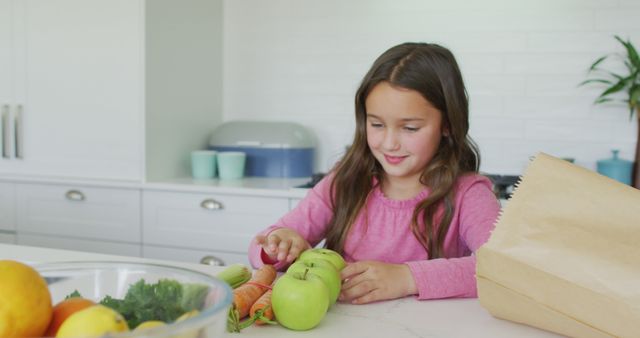 Young Girl Unpacking Groceries in Modern Kitchen - Download Free Stock Images Pikwizard.com