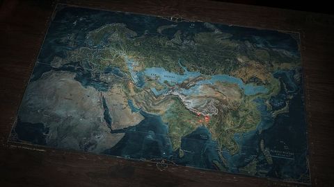 Antique parchment map of eurasia on wooden table