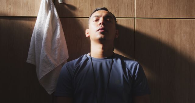 Athletic Man Resting Against Locker Room Wall - Download Free Stock Images Pikwizard.com