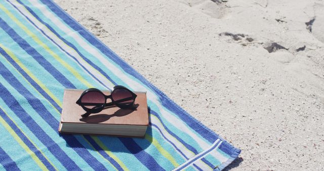 Relaxing Beach Day with Book and Sunglasses on Towel - Download Free Stock Images Pikwizard.com