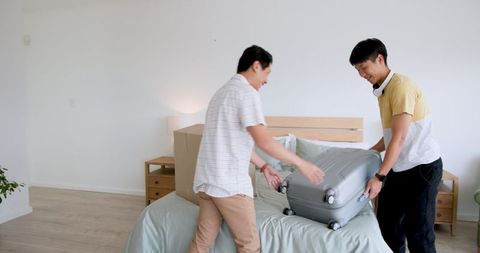 Father and son unpacking in new bedroom, embracing new beginnings