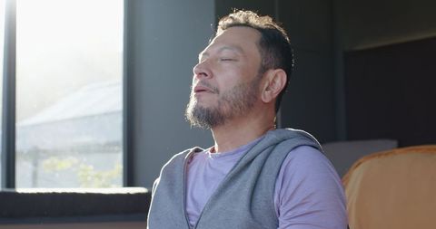 Man Relaxing in Sunlit Living Room Embracing Tranquility Indoors