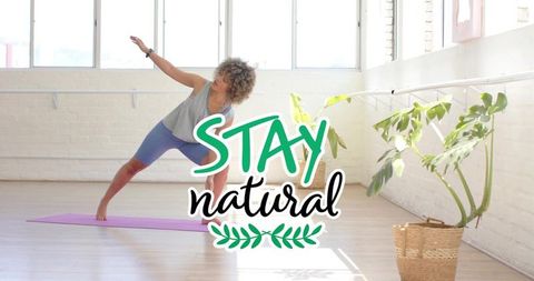 Bright minimal yoga studio woman stretching side bend on purple mat for wellness