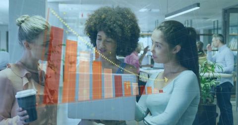 Diverse Female Team Analyzing Data in Modern Office with Chart Overlay