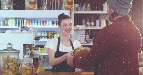 Friendly Barista Serving Fresh Artisan Bread in Cozy Coffee Shop