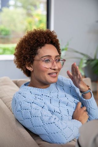 Woman in Cozy Living Room Discussing Ideas in Casual Style