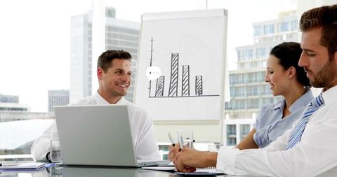 Business Team Collaborating in Modern Office with Graph Presentation