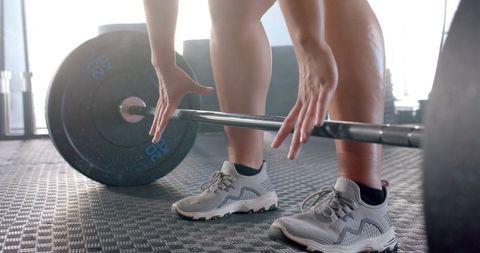 Focused Woman Preparing to Lift Weights in Gym - Download Free Stock Images Pikwizard.com