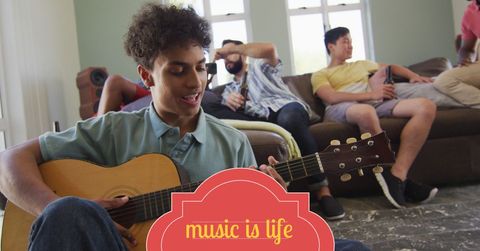 young man passionately playing guitar among smiling friends - Download Free Stock Templates Pikwizard.com