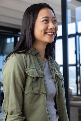 Smiling asian professional in modern office setting