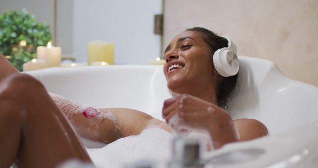 Relaxed Young Woman Listening to Music in Bubble Bath - Download Free Stock Images Pikwizard.com