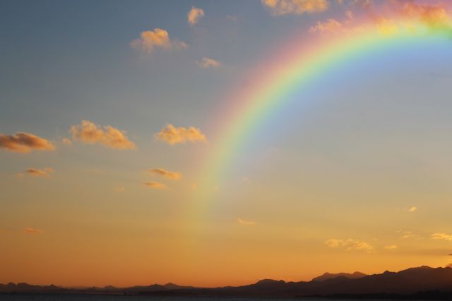 Vibrant Rainbow Arching Over Serene Mountain Sunset - Download Free Stock Photos Pikwizard.com