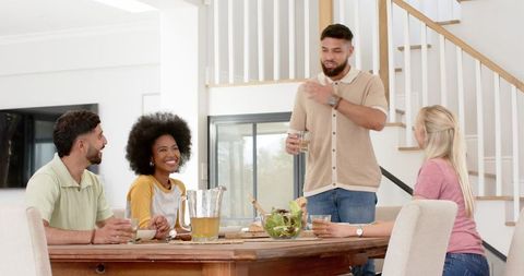 Diverse Friends Enjoying Cheerful Meal Together at Home