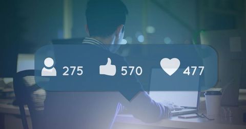 Businessman Analyzing Social Media Engagement on Laptop at Night