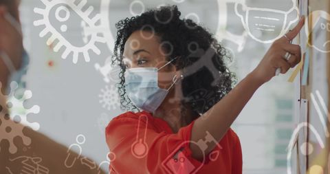 Professional team collaborating amidst covid-19 safety measures