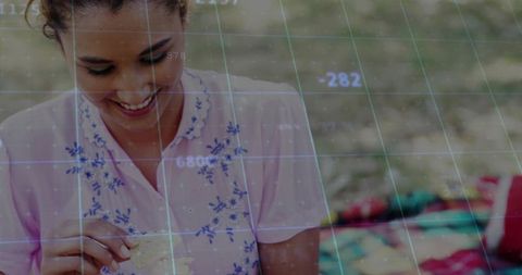 Smiling Woman Relaxing Outdoors with Futuristic Technology Overlay