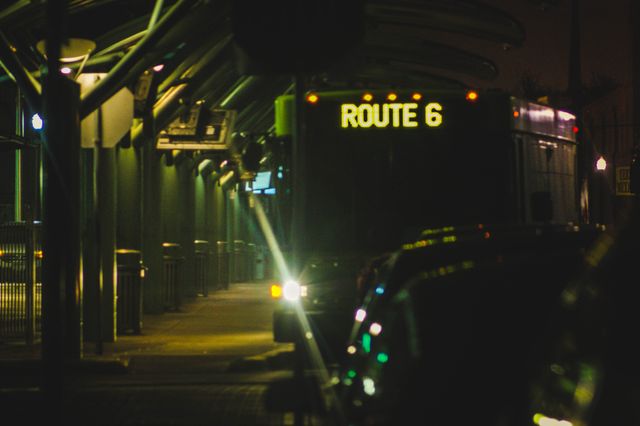 Ideal for illustrating nighttime public transportation themes, urban street photography, or city life dynamics. Can be used in articles, blogs, or marketing materials related to urban infrastructure, public transport schedules, and night commutes.