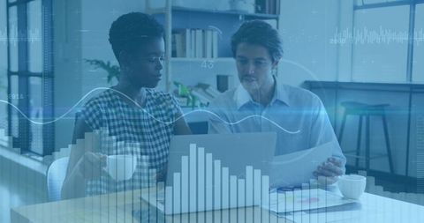 Colleagues Analyzing Digital Graphs in Modern Workspace