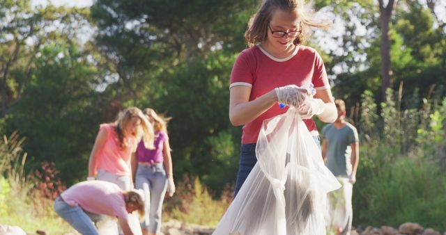Groups of people are working together in an outdoor park, collecting trash to clean up the environment. Ideal for concepts like community service, environmental conservation, teamwork, volunteer work, and civic responsibility.