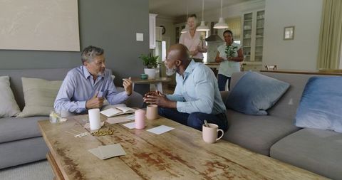 Senior friends engaging in conversation in comfortable living room
