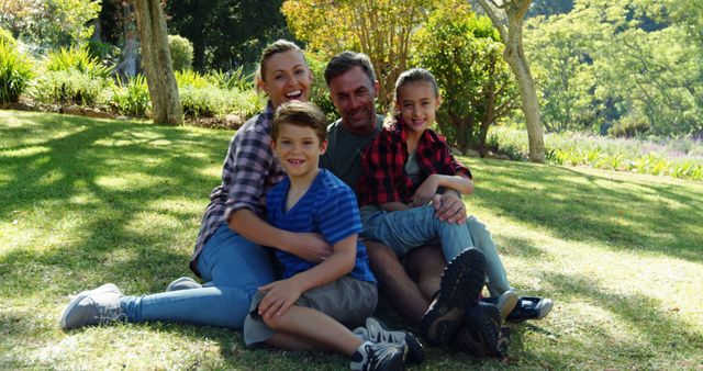 Smiling Family Bonding in Park During Sunny Day - Download Free Stock Images Pikwizard.com