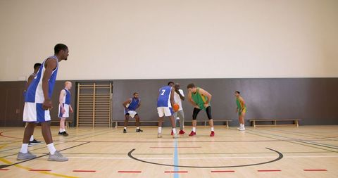 Competitive basketball game action with diverse team play