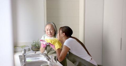 Grandmother and Granddaughter Bonding Over Kitchen Chores