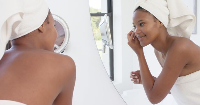 Woman Applying Makeup in Bathroom Mirror, Smiling and Wearing Towel - Download Free Stock Images Pikwizard.com