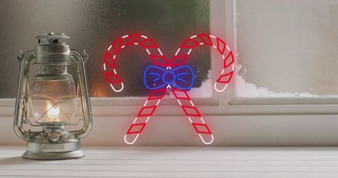 Neon Candy Canes Adorning Vintage Christmas Lantern at Frosted Window