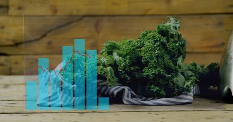 Curly kale on striped cloth with turquoise bar chart and red trend line on rustic wood