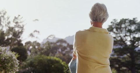 Senior Woman Enjoying Peaceful Nature Landscape in Soft Sunlight - Download Free Stock Images Pikwizard.com