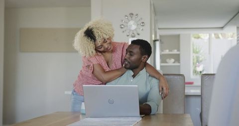 Couple Looking at Laptop Enjoying Leisure Time at Home Together