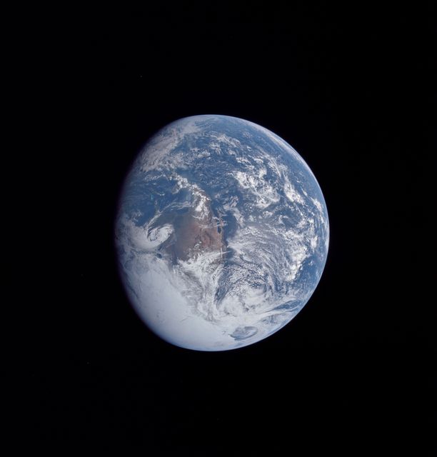 Image shows Earth from space with prominent cloud cover, captured during Apollo 16 mission on April 16, 1972. North America, including the United States, Mexico, and parts of Central America, is visible. Note details such as the Great Lakes and the Bahama Banks. Great for use in educational materials, space exploration topics, environmental discussions, and geographic studies.