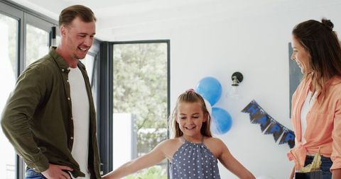 Happy Family Celebrating Daughter's Birthday in Bright Living Room