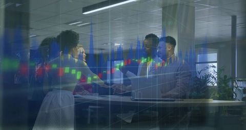 Multiracial Executives Shaking Hands at Standing Desk with Financial Candlestick Chart Overlay