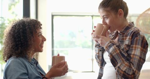 Relaxed Female Friends Sipping Beverages at Home