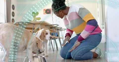 Woman Monitoring Dogs Eating in Contemporary Dining Area