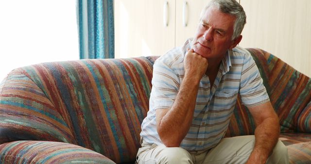 Senior Man Thinking Deeply on Colorful Couch at Home - Download Free Stock Images Pikwizard.com