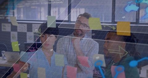 Collaborating team aligning plan on glass wall with sticky notes and digital overlay