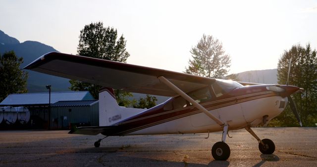 Small Airplane Parked on Runway at Sunset - Download Free Stock Images Pikwizard.com