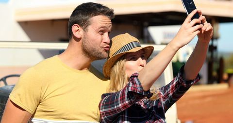 Happy Couple Taking Outdoor Selfie Under Bright Sun