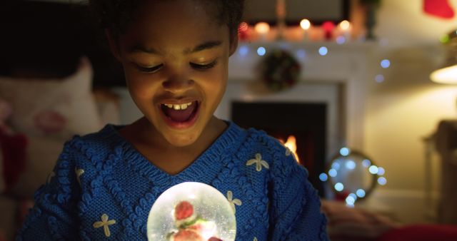 Excited Child Holding Glowing Snow Globe During Christmas - Download Free Stock Images Pikwizard.com