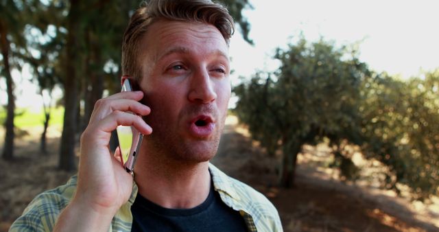 Man Surprised during Phone Call in Outdoor Setting - Download Free Stock Images Pikwizard.com